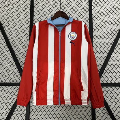 Manchester City. Cortaviento reversible Celeste/Rojo