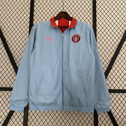 Manchester City. Cortaviento reversible Celeste/Rojo